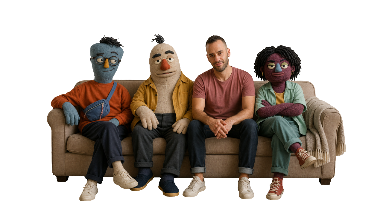 Asaf sitting on a sofa with the three textile characters